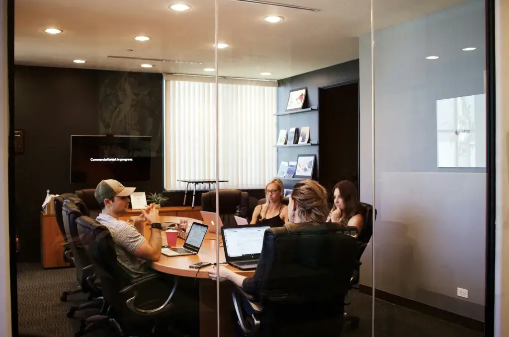 Team collaborating in a modern office meeting room work management